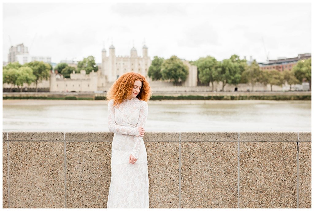 Bride in Claire Pettibone dress in front of the Thames with Tower of London in background