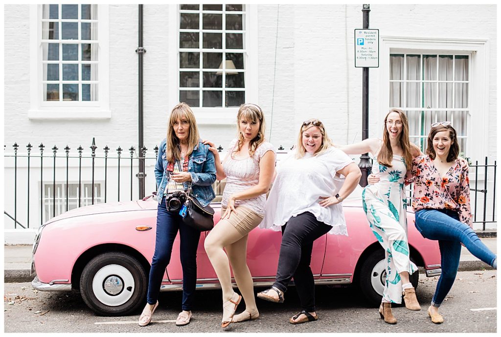 Girls in front of pink car in Notting Hill