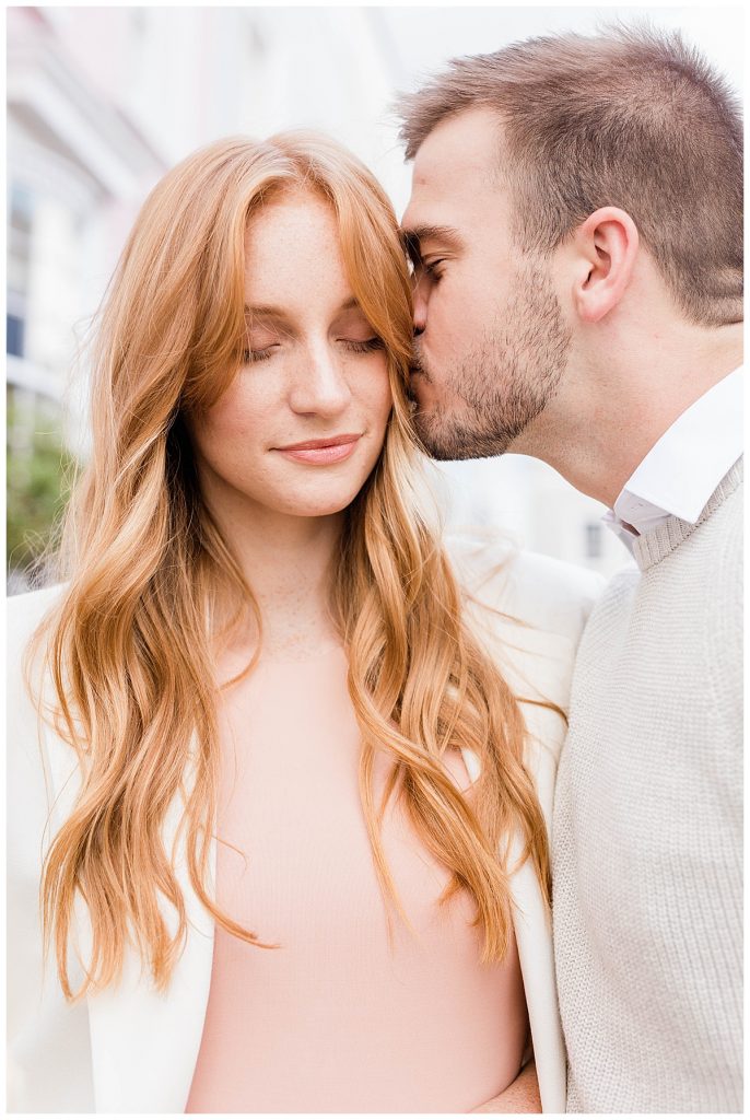 Man kissing side of woman's head